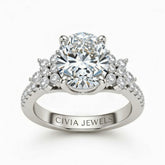 Silver Oval Cut Engagement Ring With Floral Diamond Cluster Sides And Pavé Band