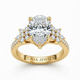 Yellow Gold Pear Cut Engagement Ring With Floral Diamond Cluster Sides And Pavé Band