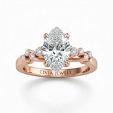 Rose Gold Marquise Cut Engagement Ring With Diamond Scatter Accent Shoulders And Classic Four-Prong Setting