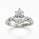 Silver Pear Cut Engagement Ring With Diamond Scatter Accent Shoulders And Classic Four-Prong Setting