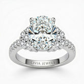 Silver Oval Cut Engagement Ring With Diamond Cluster Side Accents And Pavé Band