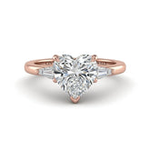Rose Gold Heart Cut Three Stone Engagement Ring With Tapered Baguette Side Diamonds And Classic Four Prong Setting