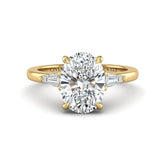 Yellow Gold Oval Cut Three Stone Engagement Ring With Tapered Baguette Side Diamonds And Classic Four Prong Setting