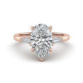 Rose Gold Pear Cut Three Stone Engagement Ring With Tapered Baguette Side Diamonds And Classic Four Prong Setting