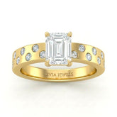 Yellow Gold Emerald Diamond Scattered Engagement Ring With Flush Set Accent Band