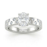 White Gold Oval Diamond Scattered Engagement Ring With Flush Set Accent Band