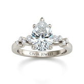White Gold Pear Cut Engagement Ring With Diamond Scatter Accent Shoulders And Classic Four-Prong Setting