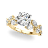 Yellow gold Round Brilliant Diamond Solitaire with Marquise and Pear Accent Stones on a Split Shank Band with Four-Prong Setting