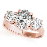 Rose gold Three-Stone Oval Cut Diamond Ring with Round Accent Stones, Prong Setting, and Classic Band