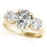 Yellow gold Three-Stone Oval Cut Diamond Ring with Round Accent Stones, Prong Setting, and Classic Band