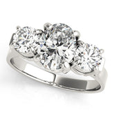 Platinum Three-Stone Oval Cut Diamond Ring with Round Accent Stones, Prong Setting, and Classic Band