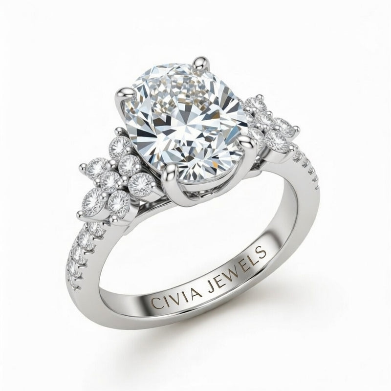 White Gold Oval Cut Engagement Ring With Floral Diamond Cluster Sides And Pavé Band