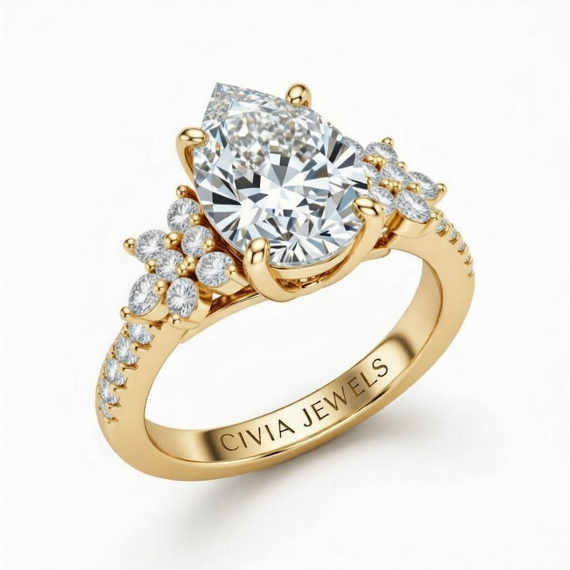Yellow Gold Pear Cut Engagement Ring With Floral Diamond Cluster Sides And Pavé Band