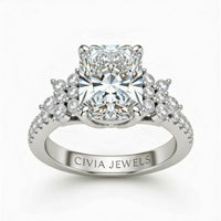 White Gold Radiant Cut Engagement Ring With Floral Diamond Cluster Sides And Pavé Band