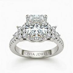 White Gold Radiant Cut Engagement Ring With Floral Diamond Cluster Sides And Pavé Band
