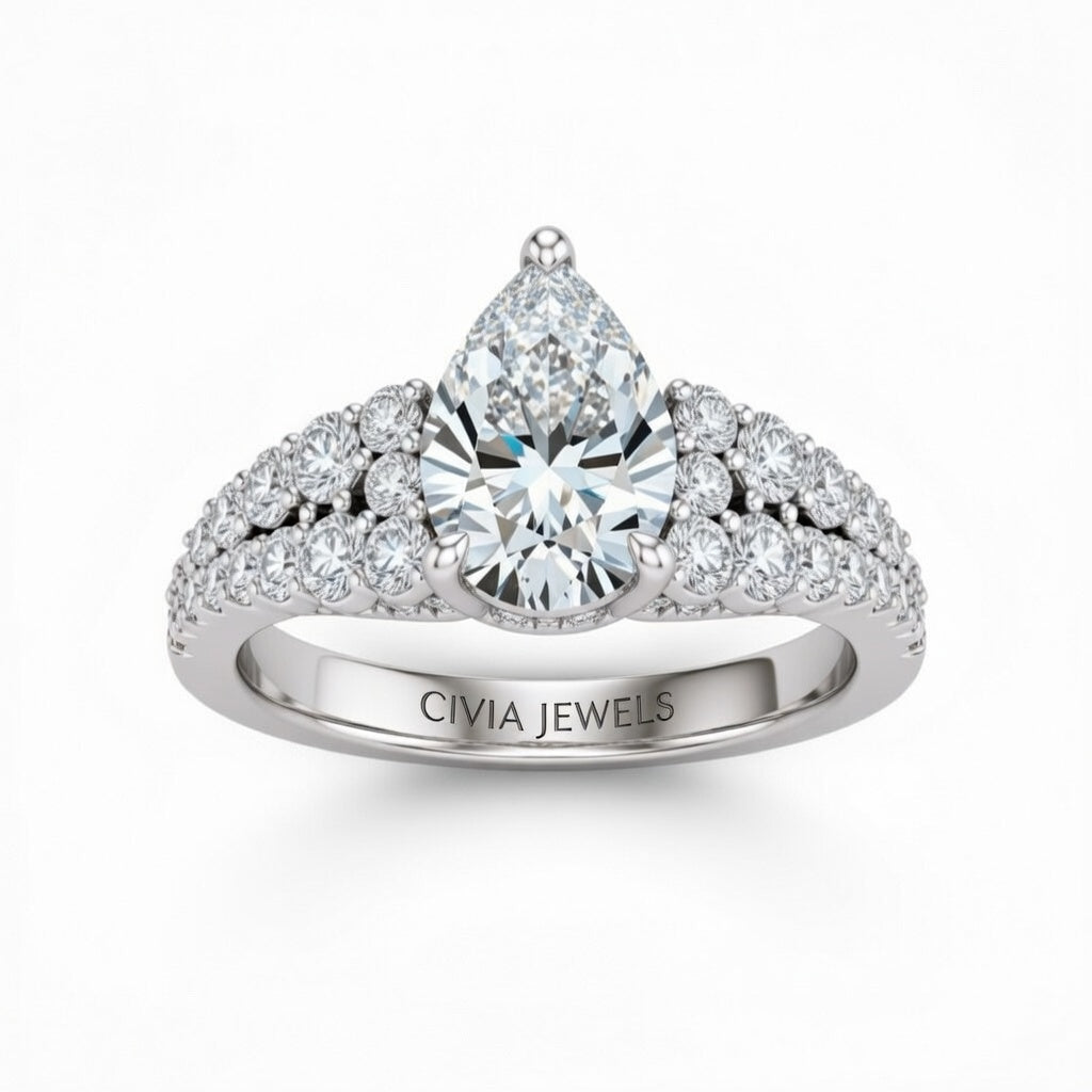 Silver Pear Cut Solitaire Engagement Ring With Pavé Diamond Band And Classic Four-Prong Setting