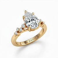 Yellow Gold Pear Cut Engagement Ring With Diamond Scatter Accent Shoulders And Classic Four-Prong Setting