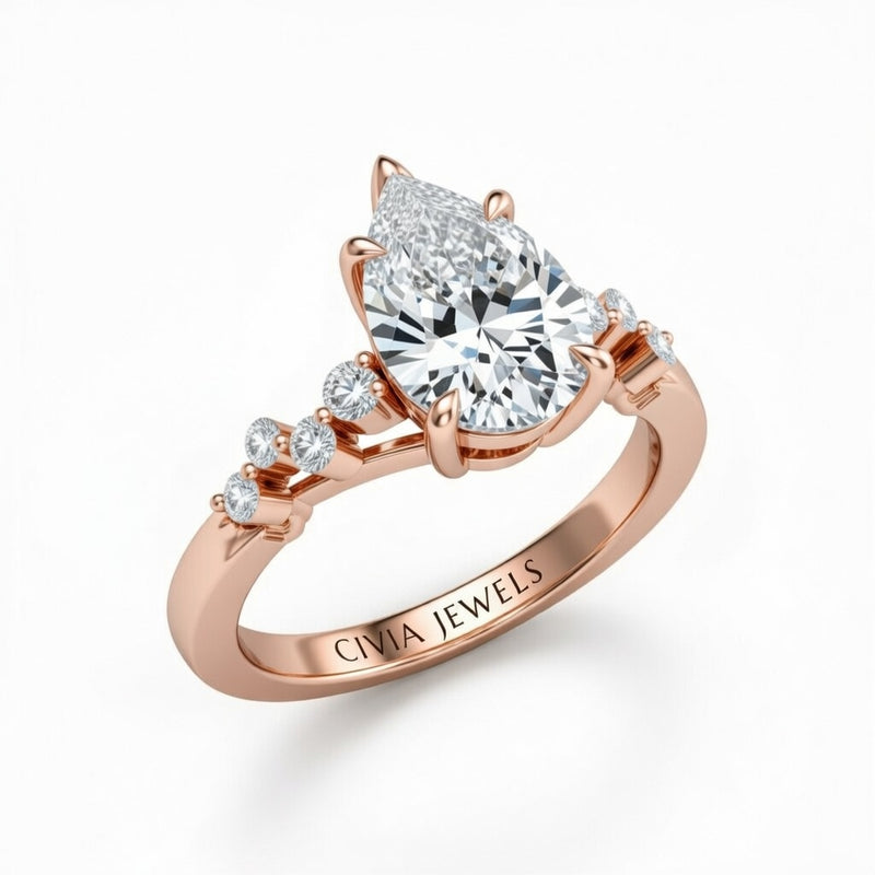 Rose Gold Pear Cut Engagement Ring With Diamond Scatter Accent Shoulders And Classic Four-Prong Setting