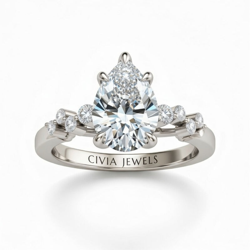 Silver Pear Cut Engagement Ring With Diamond Scatter Accent Shoulders And Classic Four-Prong Setting