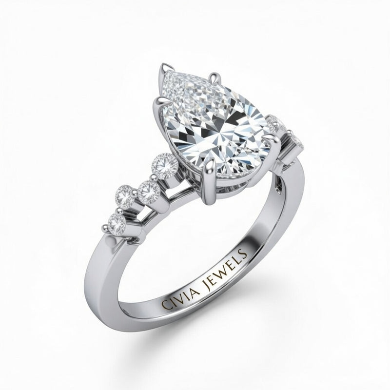 White Gold Pear Cut Engagement Ring With Diamond Scatter Accent Shoulders And Classic Four-Prong Setting