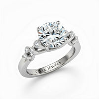 Silver Round Cut Engagement Ring With Diamond Scatter Accent Shoulders And Classic Four-Prong Setting