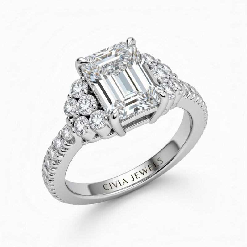 Silver Emerald Cut Engagement Ring With Diamond Cluster Side Accents And Pavé Band