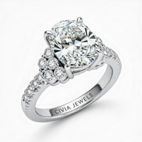 White Gold Oval Cut Engagement Ring With Diamond Cluster Side Accents And Pavé Band