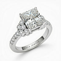 White Gold Radiant Cut Engagement Ring With Diamond Cluster Side Accents And Pavé Band