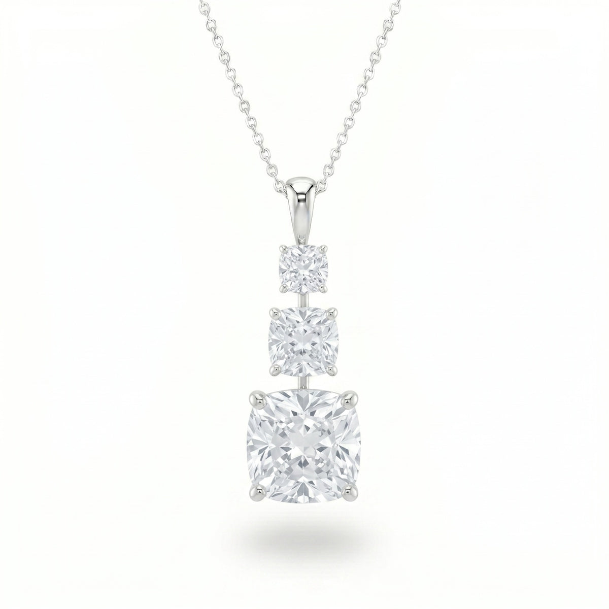 Silver Cushion Brilliant Trivessa Diamond Graduated Drop Pendant Necklace With Triple Stone Prong Setting