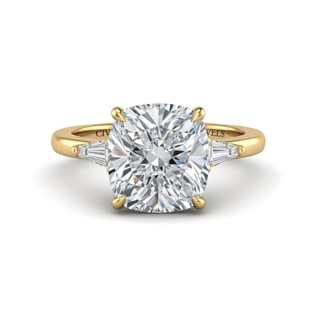 Yellow Gold Cushion Cut Three Stone Engagement Ring With Tapered Baguette Side Diamonds And Classic Four Prong Setting
