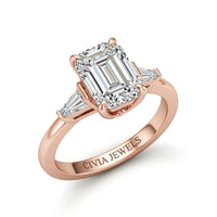 Rose Gold Emerald Cut Three Stone Engagement Ring With Tapered Baguette Side Diamonds And Classic Four Prong Setting
