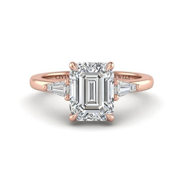 Rose Gold Emerald Cut Three Stone Engagement Ring With Tapered Baguette Side Diamonds And Classic Four Prong Setting