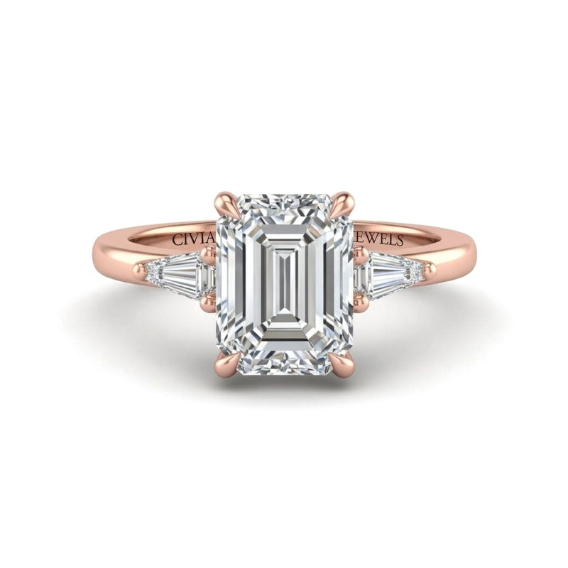 Rose Gold Emerald Cut Three Stone Engagement Ring With Tapered Baguette Side Diamonds And Classic Four Prong Setting