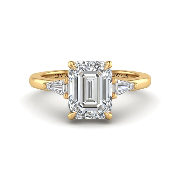 Yellow Gold Emerald Cut Three Stone Engagement Ring With Tapered Baguette Side Diamonds And Classic Four Prong Setting