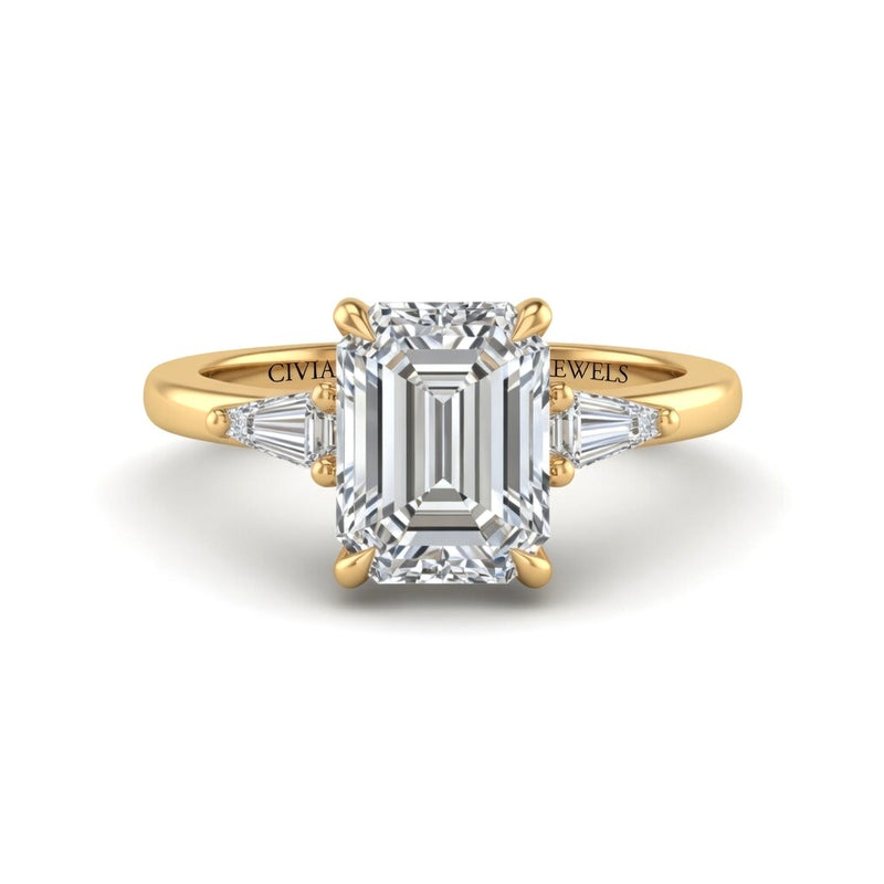 Yellow Gold Emerald Cut Three Stone Engagement Ring With Tapered Baguette Side Diamonds And Classic Four Prong Setting