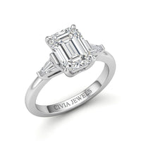 White Gold Emerald Cut Three Stone Engagement Ring With Tapered Baguette Side Diamonds And Classic Four Prong Setting