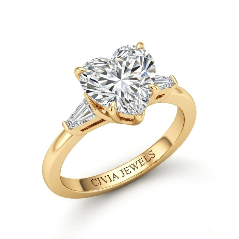 Yellow Gold Heart Cut Three Stone Engagement Ring With Tapered Baguette Side Diamonds And Classic Four Prong Setting