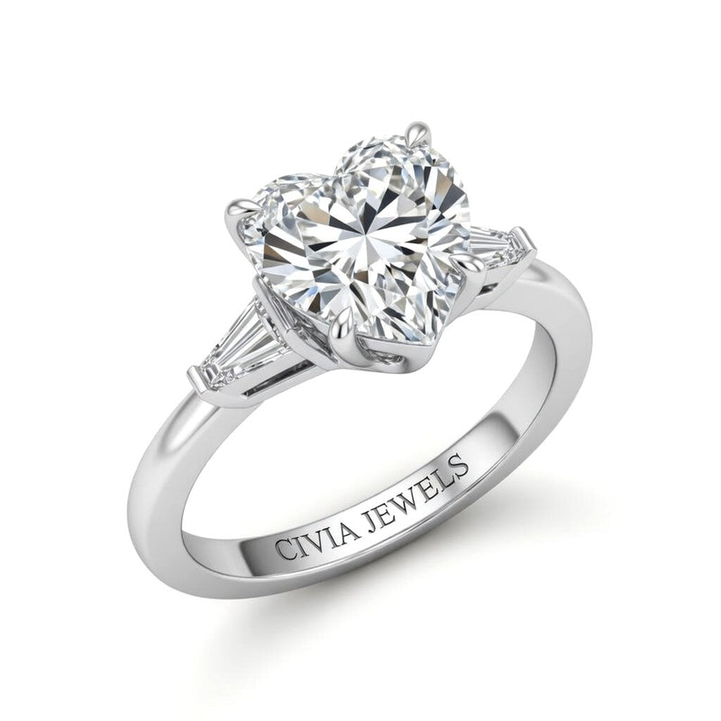 White Gold Heart Cut Three Stone Engagement Ring With Tapered Baguette Side Diamonds And Classic Four Prong Setting