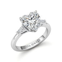 Silver Heart Cut Three Stone Engagement Ring With Tapered Baguette Side Diamonds And Classic Four Prong Setting