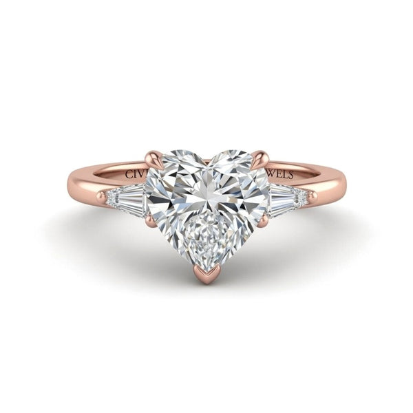 Rose Gold Heart Cut Three Stone Engagement Ring With Tapered Baguette Side Diamonds And Classic Four Prong Setting