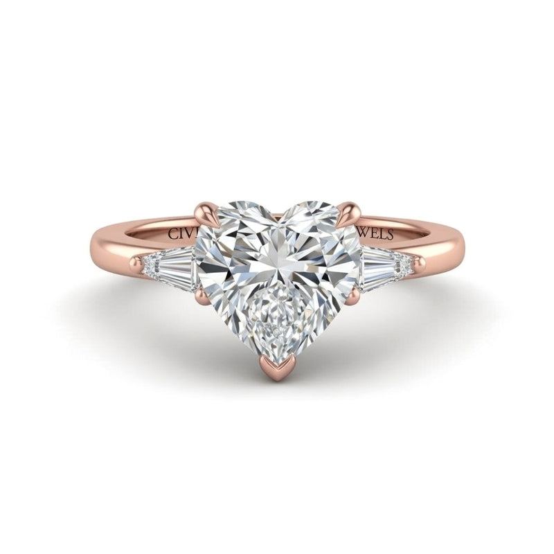 Rose Gold Heart Cut Three Stone Engagement Ring With Tapered Baguette Side Diamonds And Classic Four Prong Setting