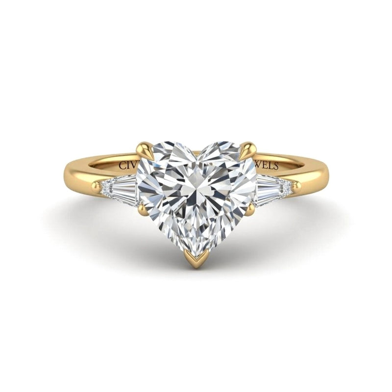 Yellow Gold Heart Cut Three Stone Engagement Ring With Tapered Baguette Side Diamonds And Classic Four Prong Setting