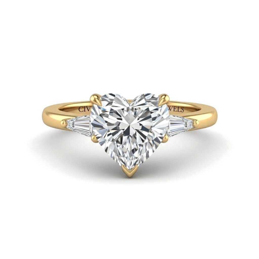 Yellow Gold Heart Cut Three Stone Engagement Ring With Tapered Baguette Side Diamonds And Classic Four Prong Setting
