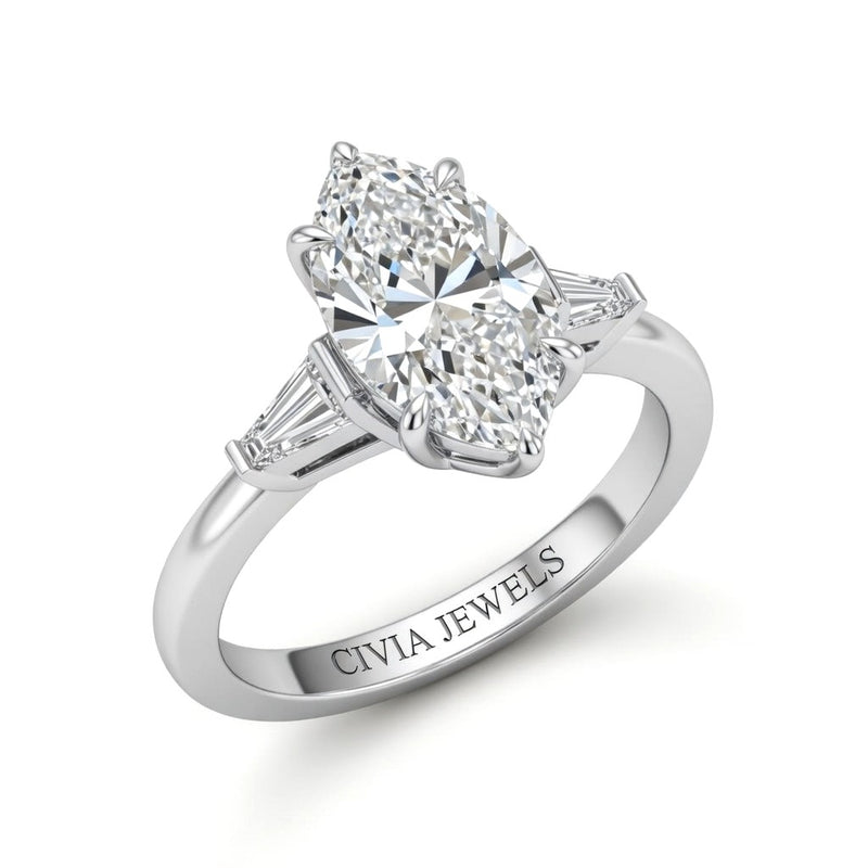 White Gold Marquise Cut Three Stone Engagement Ring With Tapered Baguette Side Diamonds And Classic Four Prong Setting