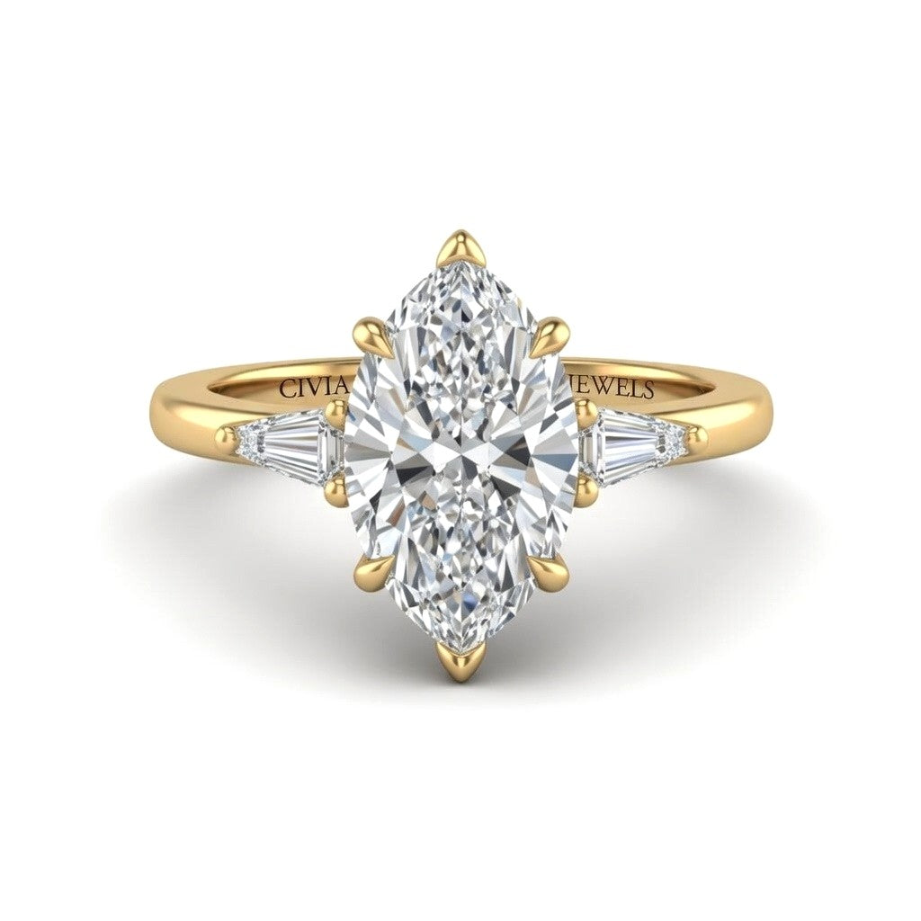 Yellow Gold Marquise Cut Three Stone Engagement Ring With Tapered Baguette Side Diamonds And Classic Four Prong Setting
