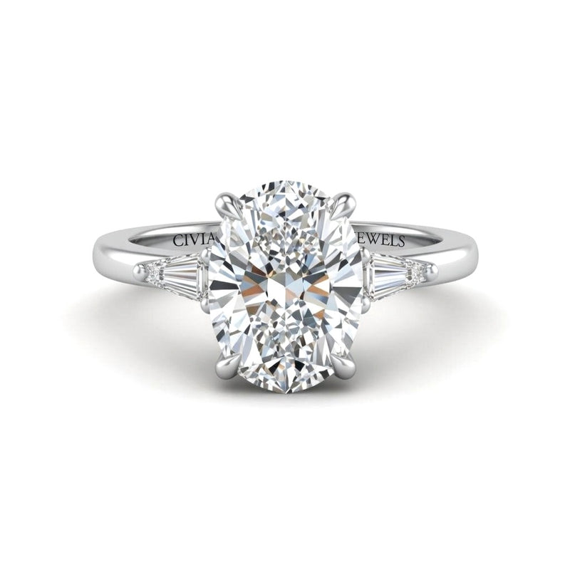 White Gold Oval Cut Three Stone Engagement Ring With Tapered Baguette Side Diamonds And Classic Four Prong Setting