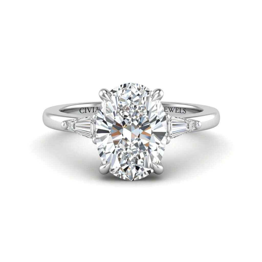 White Gold Oval Cut Three Stone Engagement Ring With Tapered Baguette Side Diamonds And Classic Four Prong Setting