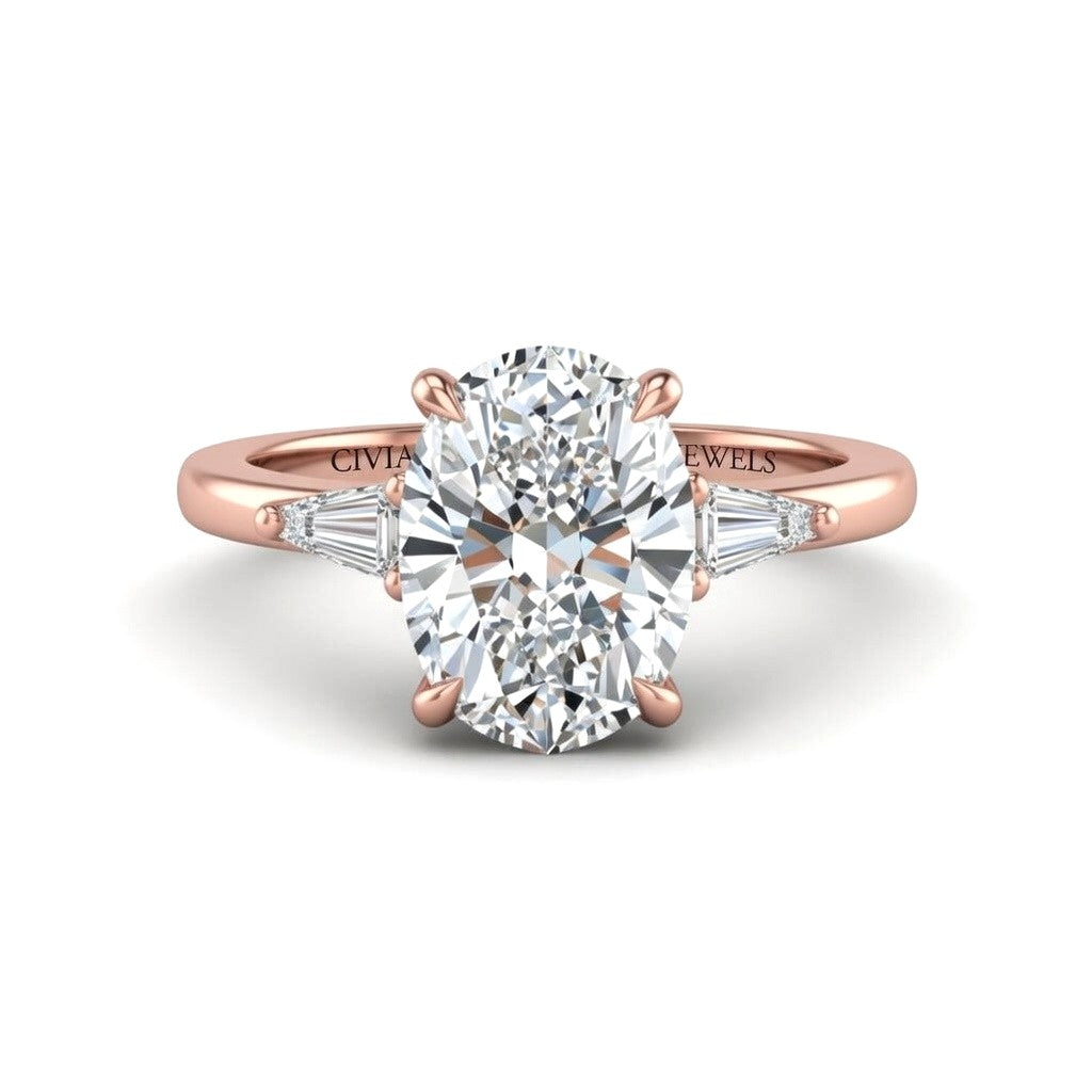 Rose Gold Oval Cut Three Stone Engagement Ring With Tapered Baguette Side Diamonds And Classic Four Prong Setting