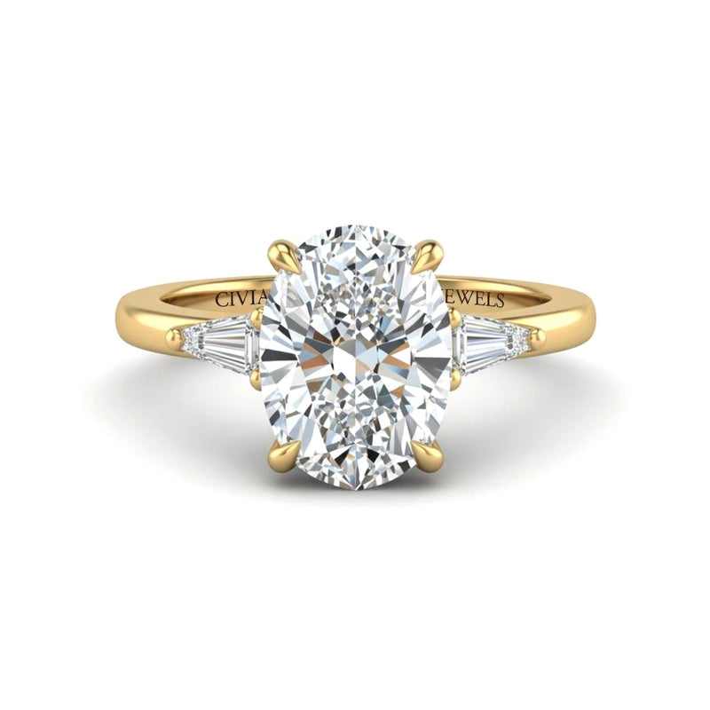 Yellow Gold Oval Cut Three Stone Engagement Ring With Tapered Baguette Side Diamonds And Classic Four Prong Setting