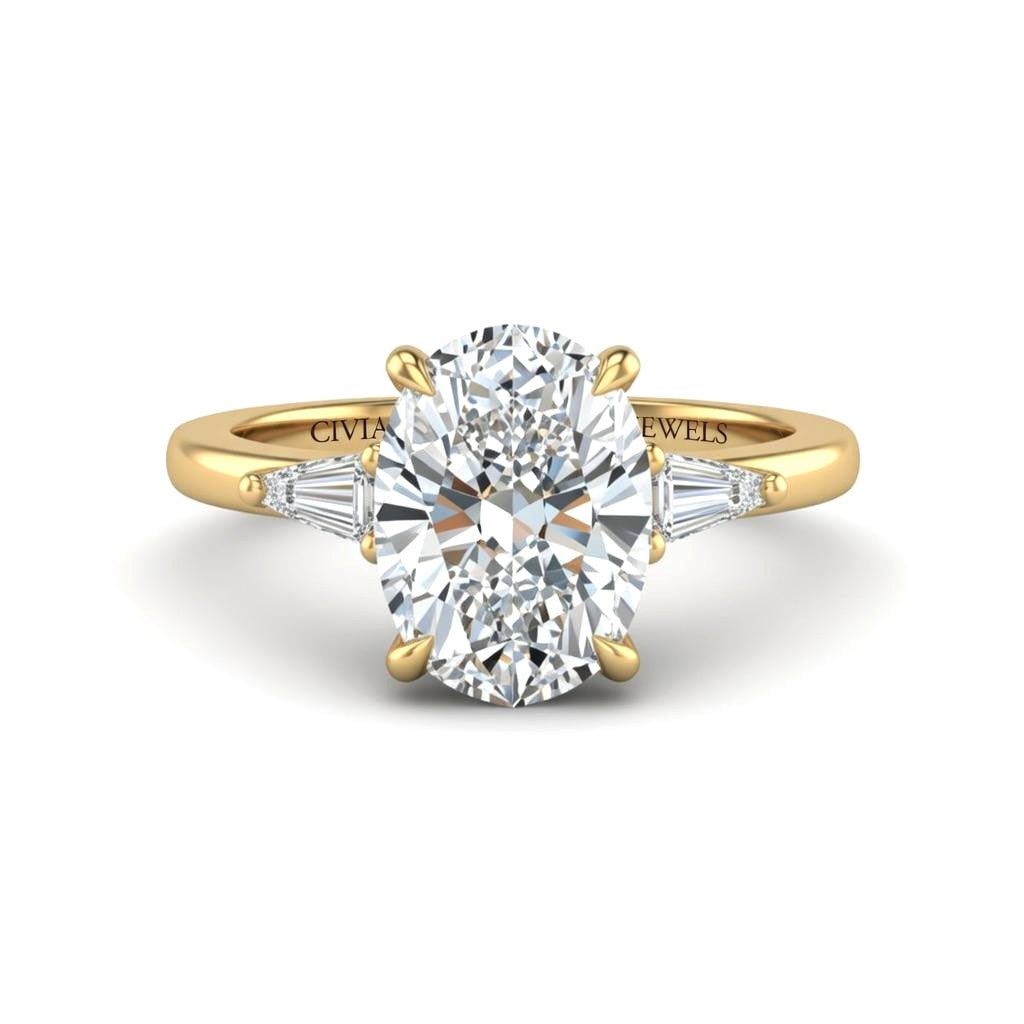 Yellow Gold Oval Cut Three Stone Engagement Ring With Tapered Baguette Side Diamonds And Classic Four Prong Setting